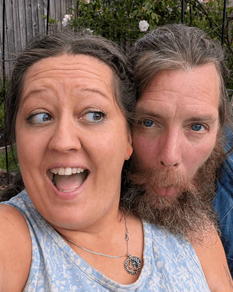 Niki and G pulling faces together in the garden