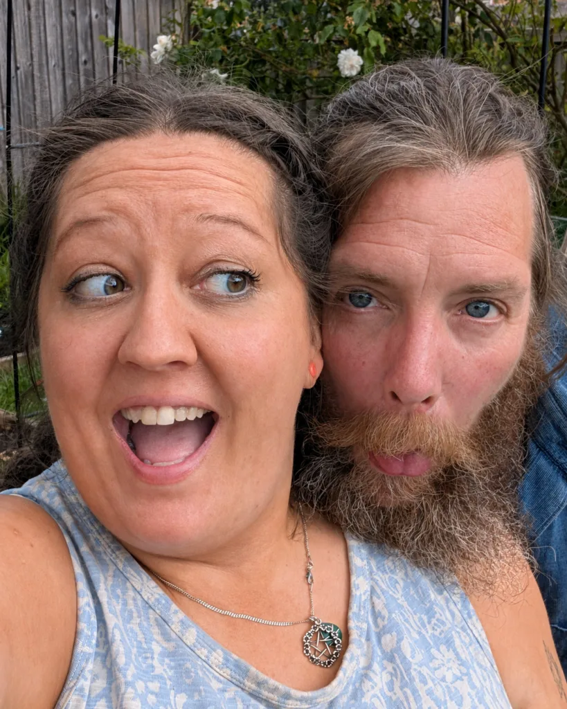 Niki and G pulling faces together in the garden